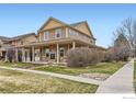 Beautiful two-story home with a covered porch, stone accents, and well-manicured landscaping at 2339 Whistler Dr, Longmont, CO 80504