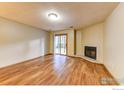 Bright living room featuring hardwood floors, a corner fireplace, and a sliding door leading to the backyard at 2865 Sundown Ln # 108, Boulder, CO 80303