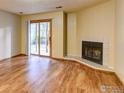 Bright living room featuring hardwood floors, a corner fireplace, and a sliding door leading to the backyard at 2865 Sundown Ln # 108, Boulder, CO 80303