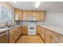 Bright kitchen featuring wooden cabinets, stainless steel appliances, and hardwood floors at 3006 W 107Th Pl # D, Westminster, CO 80031