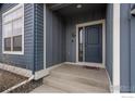 Close-up of a charming front door with a small porch, offering a warm welcome to visitors at 316 Rhubarb Dr, Berthoud, CO 80513
