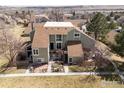 An eye-level, elevated view of a two-story home showcasing a cozy patio and a well-manicured front yard at 3187 Redstone Ln # G, Boulder, CO 80305