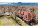 Aerial view featuring a community with well-manicured grounds, mountains, and mature trees at 3250 Oneal Cir # 23, Boulder, CO 80301