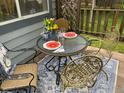 Charming patio with outdoor seating, a glass-top table set for two, and decorative blue accents at 3349 Sentinel Dr, Boulder, CO 80301