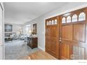 Inviting entryway with hardwood floors and decorative wood door with glass window features at 3762 W 99Th Ave, Westminster, CO 80031
