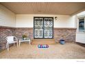 Inviting covered front porch with decorative wrought iron doors and a cozy seating area at 3762 W 99Th Ave, Westminster, CO 80031