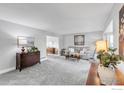 Spacious living room with plush gray carpeting and abundant natural light at 3762 W 99Th Ave, Westminster, CO 80031