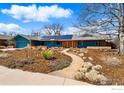 Beautifully landscaped front yard leading to a charming home with solar panels on the roof at 385 Erie Dr, Boulder, CO 80303