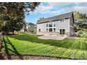 Expansive backyard featuring lush lawn, mature trees, and a white picket fence, perfect for outdoor enjoyment at 6850 Sage Ave, Firestone, CO 80504