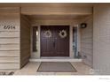 Inviting front entrance with double doors adorned with wreaths and sidelights at 6914 Frying Pan Rd, Boulder, CO 80301