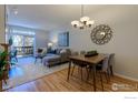 Open-concept living space with dining area and balcony, features a modern sofa and stylish decor at 7419 Singing Hills Ct, Boulder, CO 80301