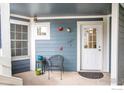 Cozy porch seating area with a window and white door at 11197 Alcott St # C, Denver, CO 80234