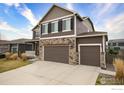 Beautiful two-story home with a three-car garage and well-maintained landscaping at 1401 Vantage Pkwy, Berthoud, CO 80513