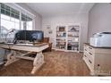 Bright home office featuring built-in bookshelves and ample desk space at 1401 Vantage Pkwy, Berthoud, CO 80513