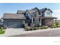 Charming two-story home with a beautifully landscaped yard and inviting stone accents at 1563 Stoneseed St, Berthoud, CO 80513