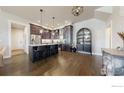 Stylish kitchen with dark wood cabinets, quartz countertops, and stainless steel appliances at 1563 Stoneseed St, Berthoud, CO 80513