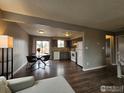 Open dining area adjacent to the kitchen, featuring hardwood floors and sliding doors to an outdoor deck at 2252 Smith Dr, Longmont, CO 80501