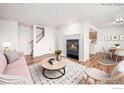 Staged living room with hardwood floors, fireplace, and view to dining area at 2254 Spruce St # A, Boulder, CO 80302