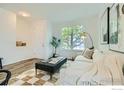 Bright living room with a large window, modern decor, and stylish furniture at 230 Bonanza Dr, Erie, CO 80516
