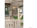 Landscaped front yard with wood fence, walkway and number 247 on a decorative post at 247 Rendezvous Dr, Lafayette, CO 80026