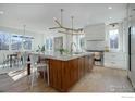 Bright kitchen featuring a large island with seating and a dining area with large windows at 2700 15Th St, Boulder, CO 80304