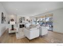 Elegant living room with a fireplace, stylish furniture, and sliding glass doors to the patio at 2700 15Th St, Boulder, CO 80304