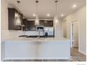 Bright kitchen with stainless steel appliances, granite countertops, and pendant lighting at 2754 Bear Springs Cir, Longmont, CO 80503