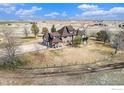 Aerial view of a stunning home featuring the large backyard and mature trees at 28800 E 168Th Ave, Brighton, CO 80603