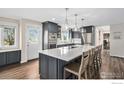 Well-appointed kitchen with a large island, stainless steel appliances, and stylish gray cabinetry at 28800 E 168Th Ave, Brighton, CO 80603