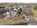 An aerial view showcases this blue home with solar panels and picturesque views of surrounding neighborhood at 301 Indian Peaks W Trl, Lafayette, CO 80026