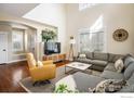 Bright living room with a vaulted ceiling, hardwood floors, a neutral color palette, and ample natural light at 301 Indian Peaks W Trl, Lafayette, CO 80026