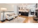 Bright living room showcases hardwood floors, a modern sofa, and an open-concept kitchen with stainless steel appliances at 3035 Oneal Pkwy # V-11, Boulder, CO 80301