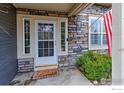 Inviting front entrance featuring a glass door, sidelights, stone accents, and a charming welcome mat at 3076 W 112Th Ct # F, Westminster, CO 80031