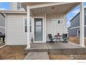 Inviting front porch with stylish seating, creating a cozy outdoor space at 317 Pyramid Peak St, Berthoud, CO 80513