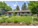 Charming single-story home with a neatly landscaped front yard and attached garage at 3545 Cloverleaf Dr, Boulder, CO 80304