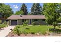 Charming single-story home featuring a well-maintained front yard with mature trees at 3545 Cloverleaf Dr, Boulder, CO 80304