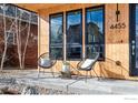 Stylish front porch features sleek chairs, a glass table, and a modern design aesthetic at 4455 Xavier St, Denver, CO 80212