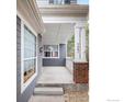 Inviting front porch with brick accents and white columns creating a welcoming entrance at 5001 Bella Vista Dr, Longmont, CO 80503