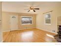 Bright living room with hardwood floors, a ceiling fan, and ample natural light at 503 E Oak St, Lafayette, CO 80026