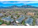 Scenic aerial view showcases a vibrant community with mountain views, lush trees, and green spaces at 550 Mohawk Dr # 67, Boulder, CO 80303