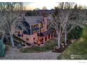 Spacious backyard features a patio with a fire pit and seating, perfect for outdoor entertaining at 567 Manorwood Ln, Louisville, CO 80027