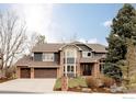 Attractive two-story home with a well-manicured lawn, brick accents, and an attached three-car garage at 567 Manorwood Ln, Louisville, CO 80027