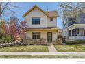 Charming two-story home with inviting front porch, well-manicured lawn and curb appeal at 596 Mills St, Lafayette, CO 80026