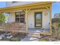 Welcoming front porch with ample space and beautiful details, perfect for enjoying quiet mornings outdoors at 596 Mills St, Lafayette, CO 80026