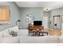 Cozy living room featuring a comfortable sofa, stylish decor, and an open layout perfect for relaxation at 629 Mcclure Ave, Firestone, CO 80520