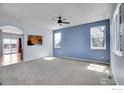 Bright and airy living room with neutral carpet, ample natural light, and view into kitchen at 6297 Clayton Cir, Frederick, CO 80530