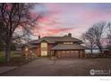 Sprawling two-story home with a three car garage, mature trees and inviting curb appeal at 7975 Anchor Dr, Longmont, CO 80504