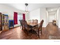 Elegant dining room featuring hardwood floors, a wooden table, and an ornate chandelier at 11180 Carbondale St, Firestone, CO 80504
