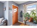 Entryway with a stylish front door, hardwood floors, and natural light, creating a warm and inviting welcome at 117 Welch Ave, Berthoud, CO 80513