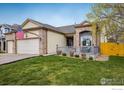 Charming home with a brick facade, two-car garage, and a cozy front porch perfect for relaxing at 13397 Franklin St, Thornton, CO 80241